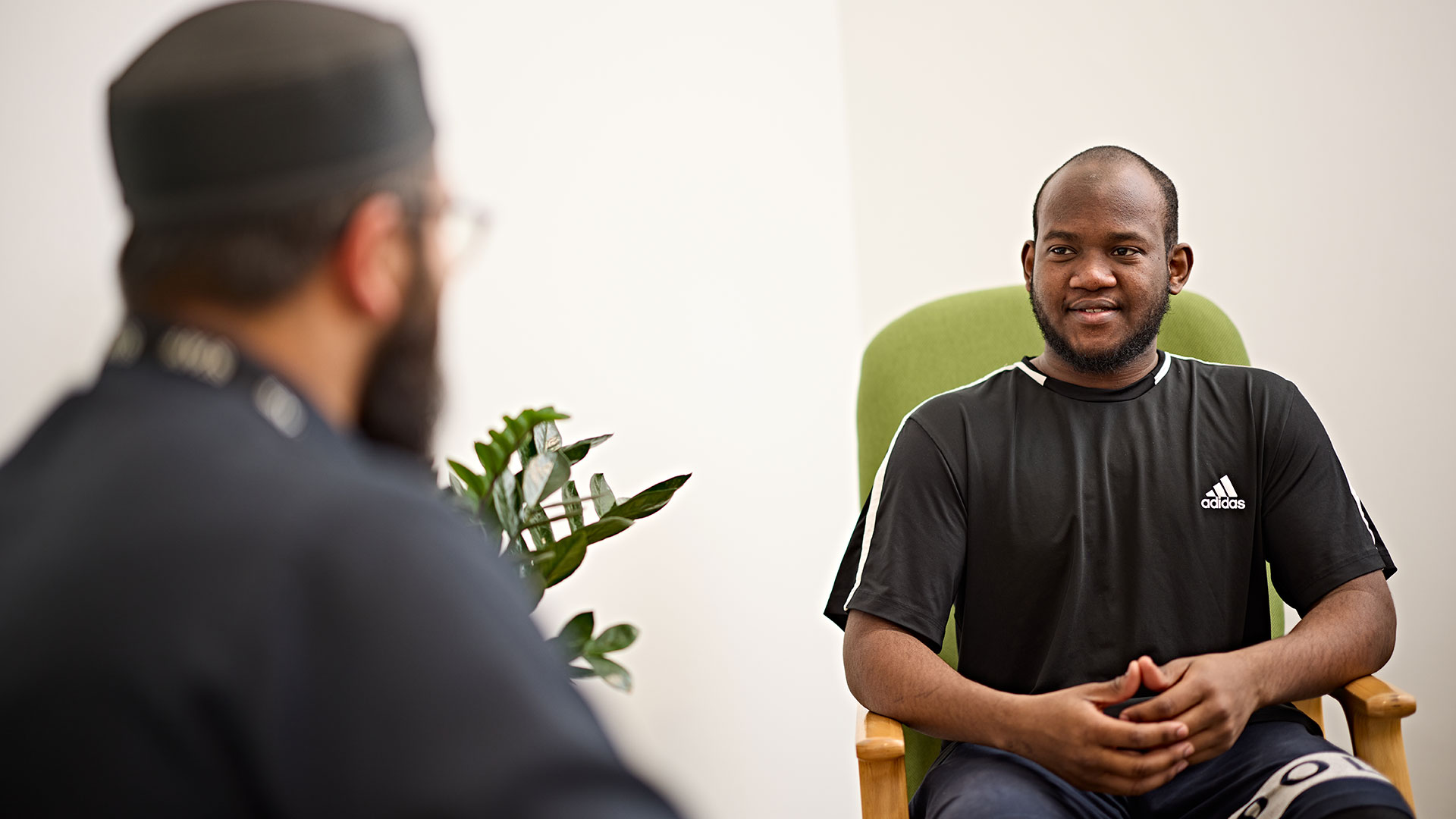 A student chats to the Muslim Chaplain in the counselling space.