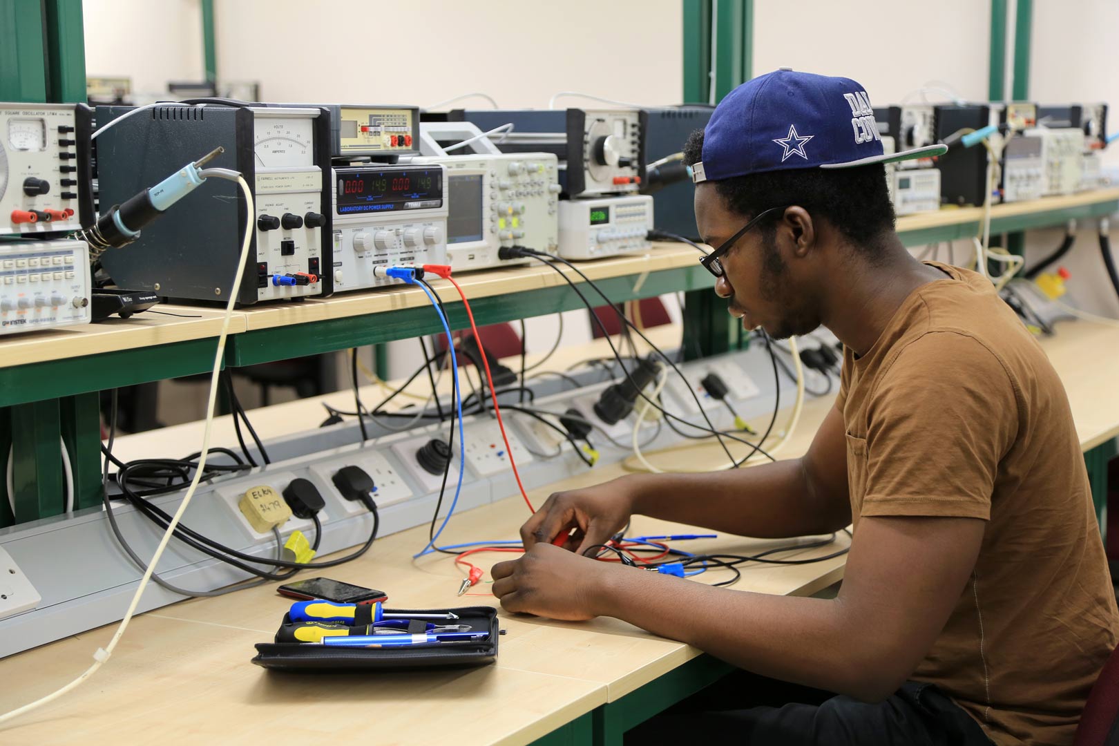 Male student in working in a Computing and Engineering electronic laboratory