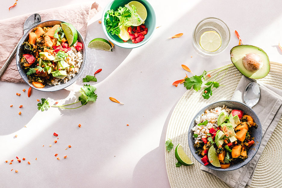 Healthy bowls of food on a crisp white tablecloth. There is much avocado. Gwyneth Paltrow is not in the image but she is probably nearby.