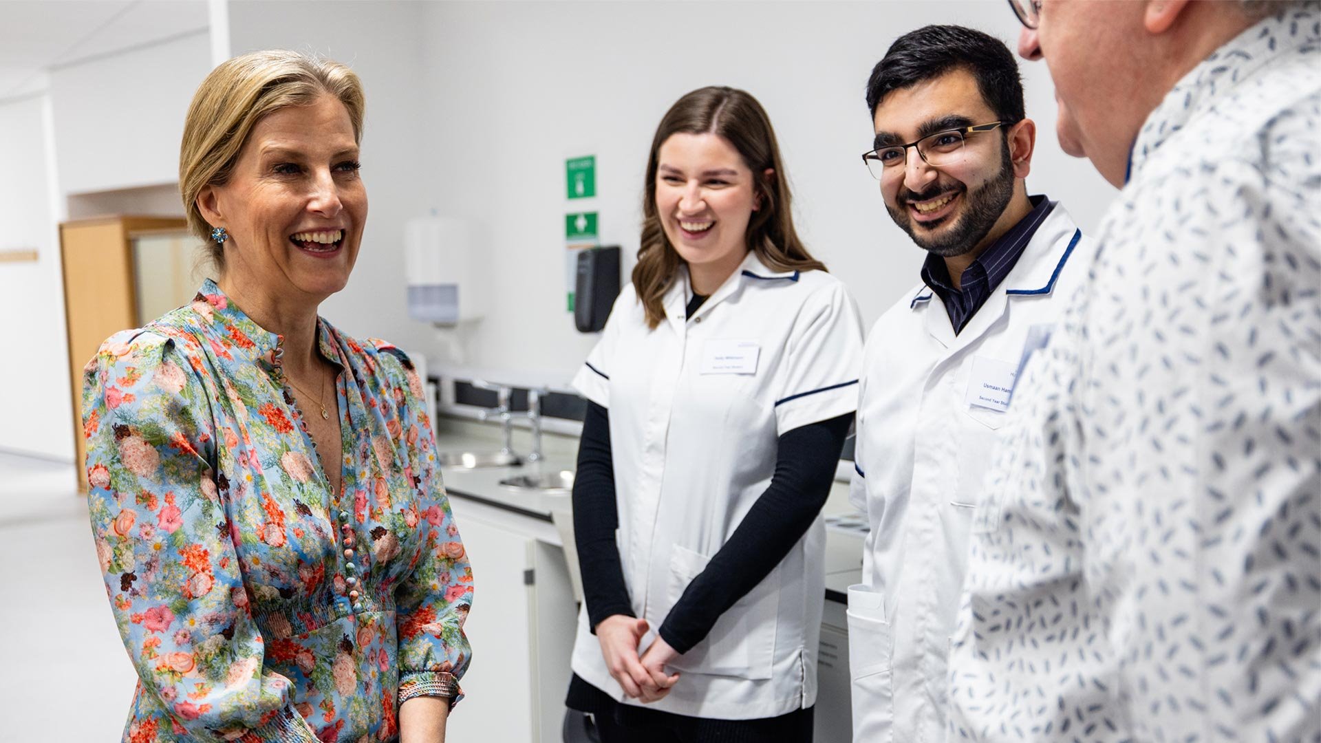 two students and a professor with the Duchess of Edinburgh