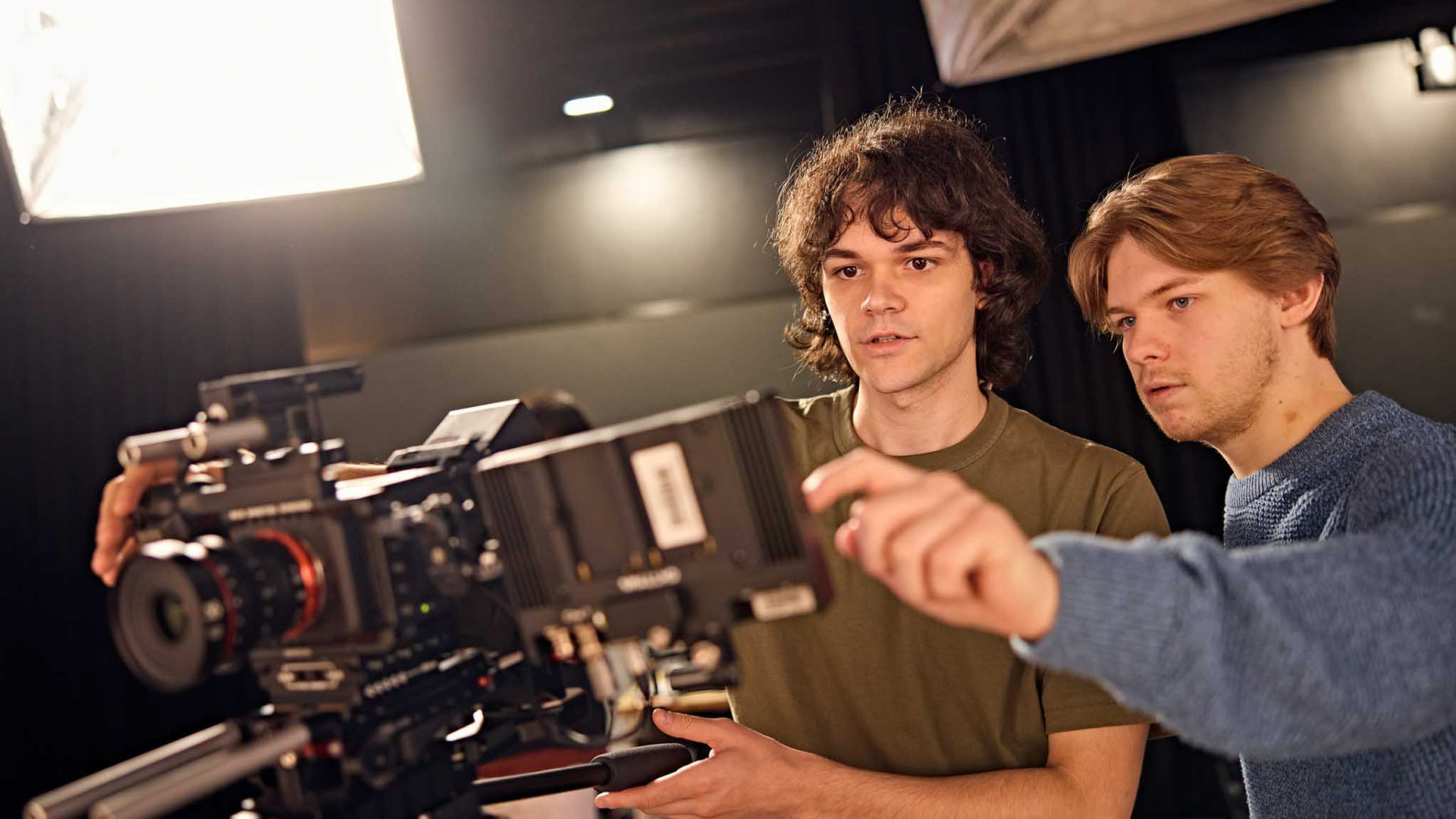 Two film students looking over footage on their camera