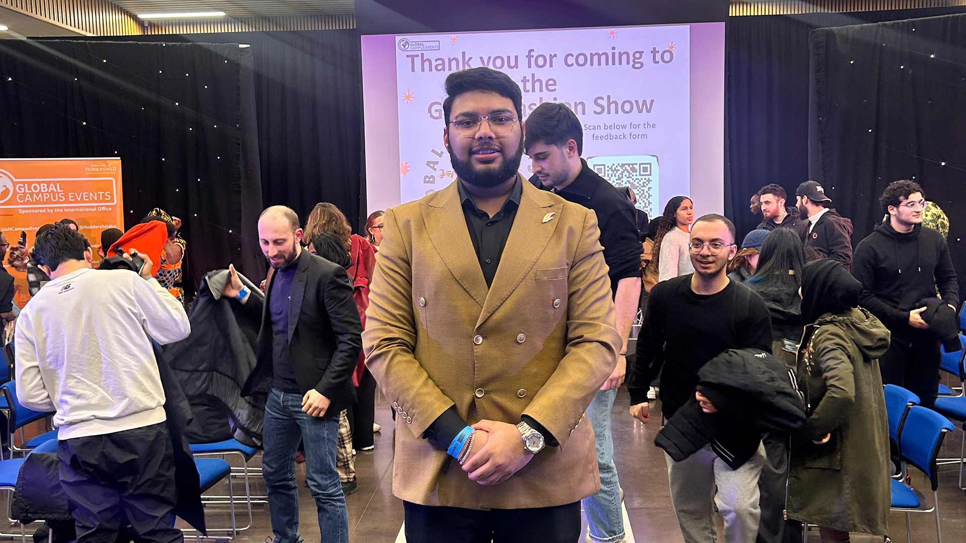 Shufan at a University event wearing a blazer.